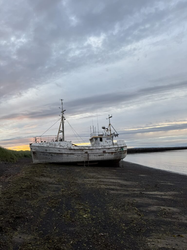The rusted remains of a shipwreck partially buried in the sand dunes near Ólafsvík on the Snæfellsnes Peninsula