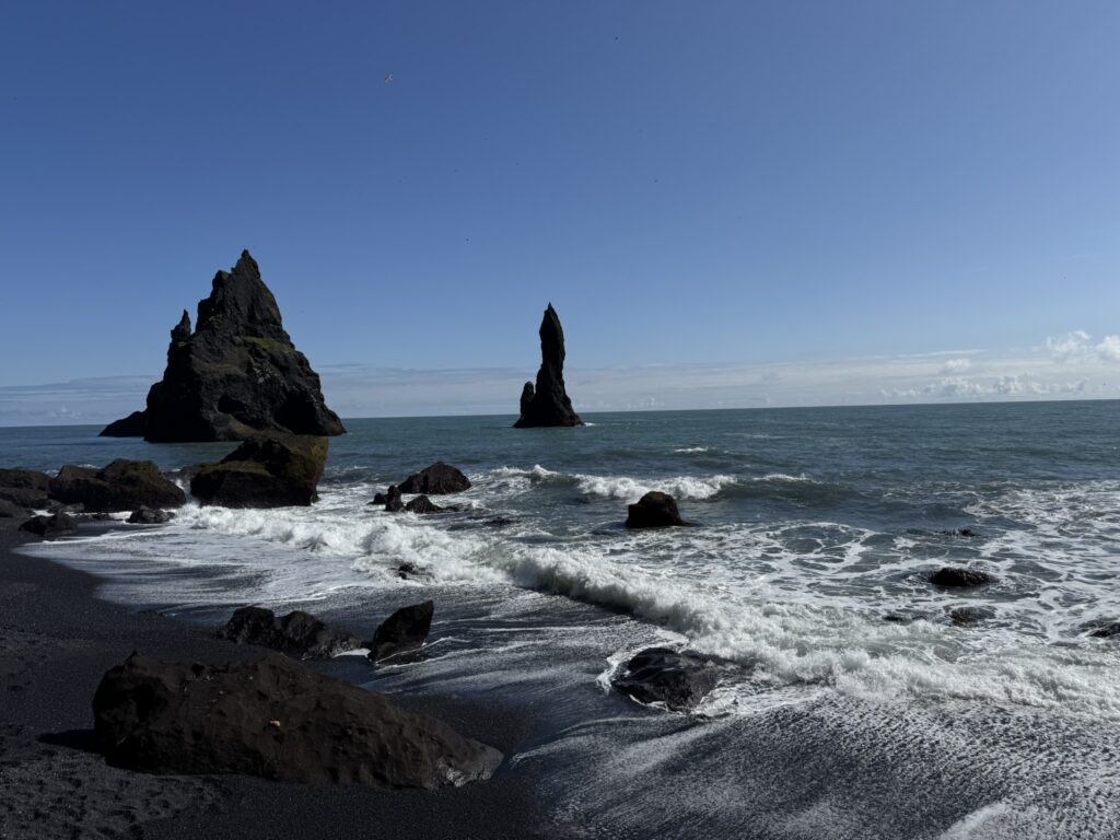 Reynisfjara black sand beach with basalt columns and Reynisdrangar sea stacks near Vik Iceland