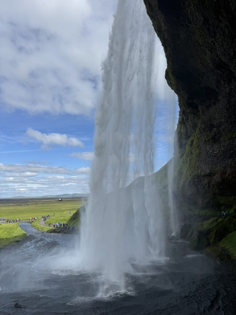 The iconic Seljalandsfoss waterfall in South Iceland with the walking path leading behind the water curtain