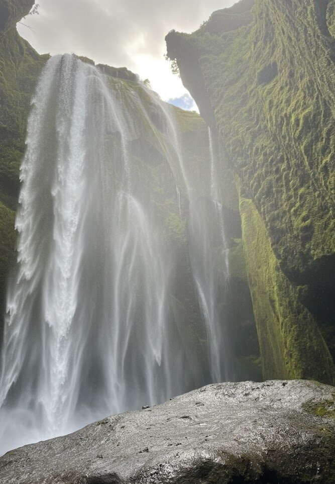 Hidden Gljufrabui waterfall inside a narrow mossy canyon on the South Coast of Iceland