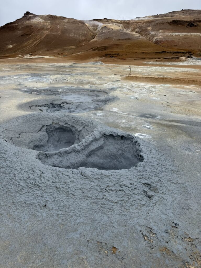 Boiling mud pots and steaming fumaroles in the colorful Hverir geothermal area near Lake Myvatn