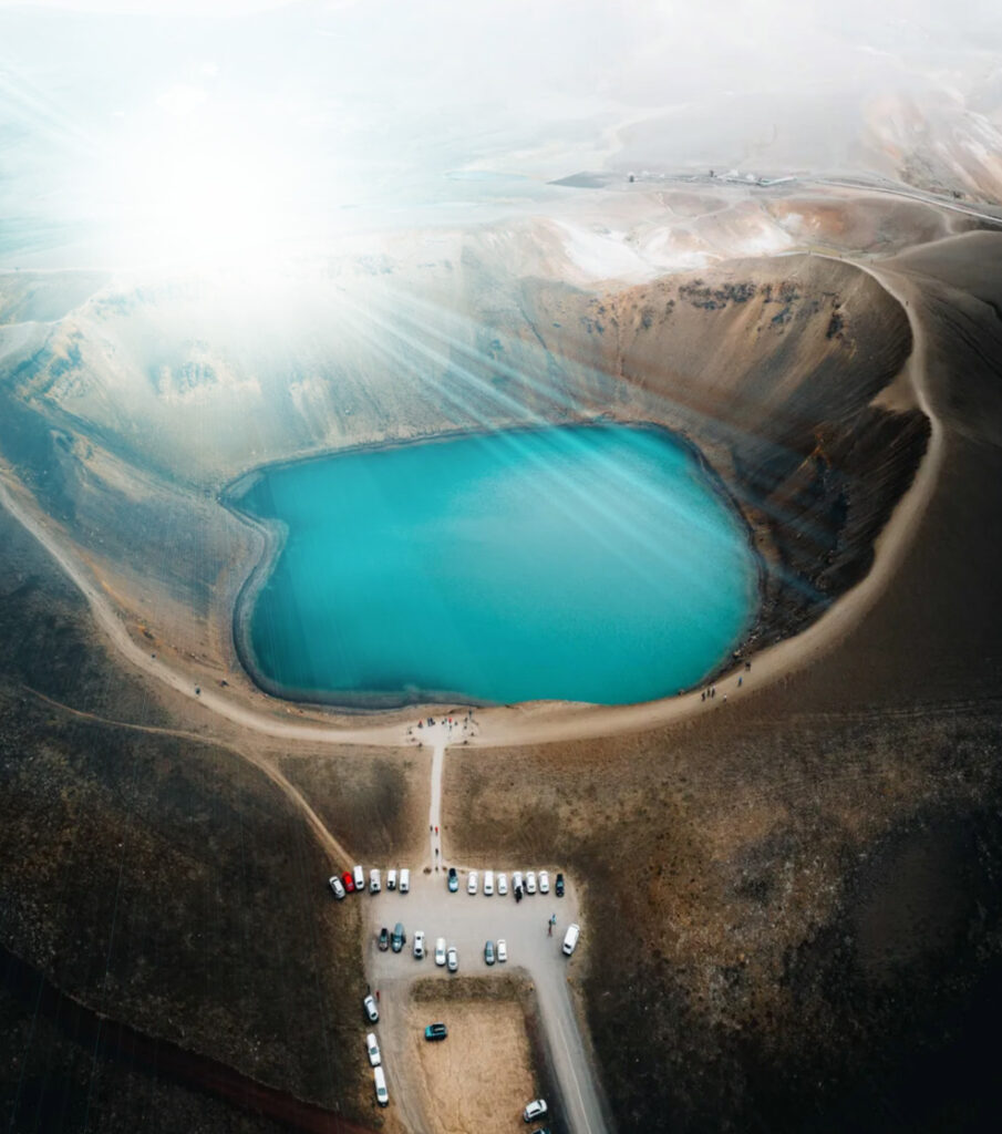 High-angle drone shot of the Krafla volcanic caldera and the blue water of Viti explosion crater in North Iceland