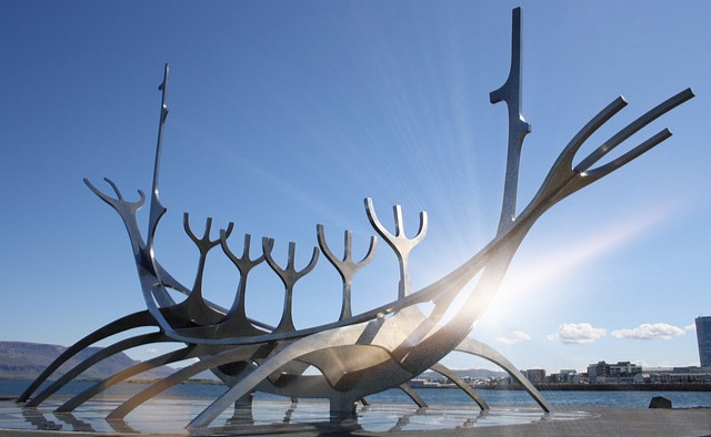 The stainless steel Sun Voyager sculpture on the Reykjavik waterfront with Mount Esja in the background