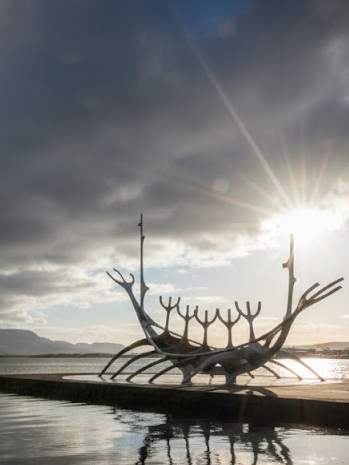 The stainless steel Sun Voyager sculpture on the Reykjavik waterfront with Mount Esja in the background