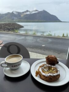 A fresh Icelandic cinnamon roll (Snúður) and coffee at Geirabakarí Kaffihús bakery in Borgarnes.
