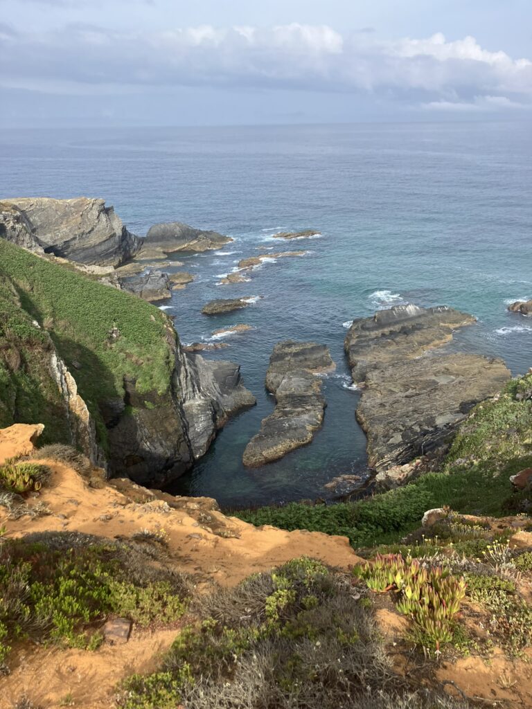 Rocky Atlantic cliffs along the Fishermen's Trail Portugal with turquoise ocean water below