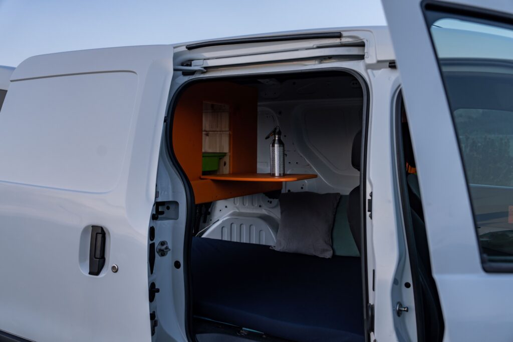 Interior of a Go Campers minivan campervan in Iceland, fitted out with a bed and cooking kit