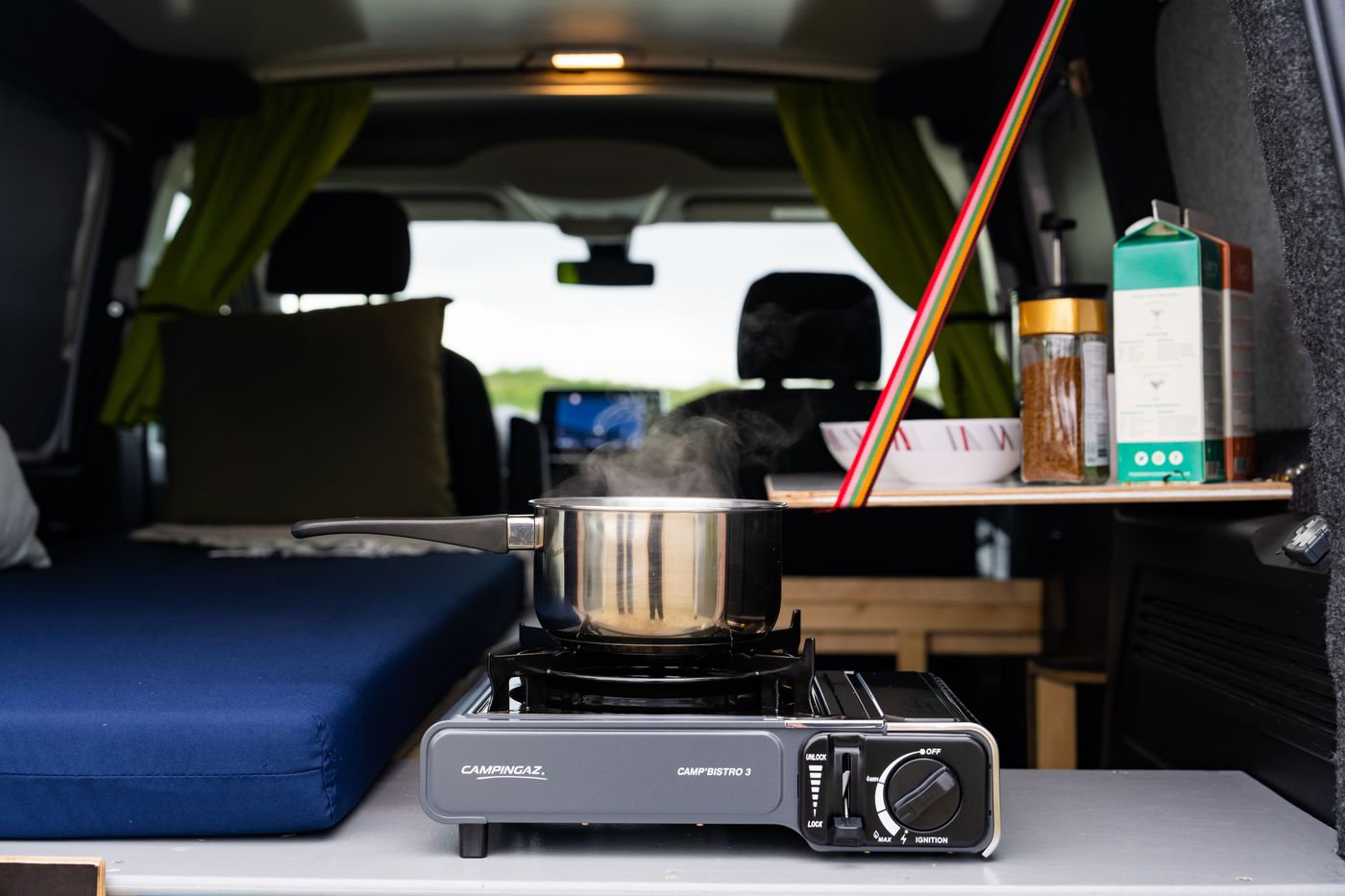Cooking on a gas stove inside a Go Campers campervan in Iceland