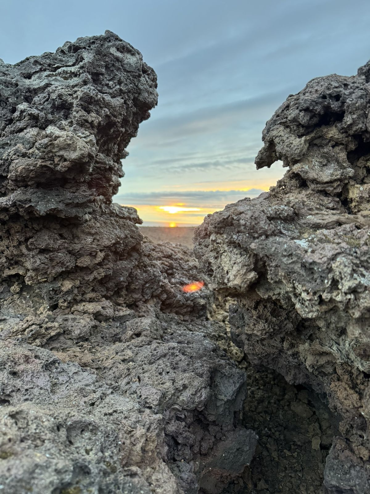 Sunset seen through a gap in the lava rocks at Hellissandi campsite on the Snaefellsnes peninsula